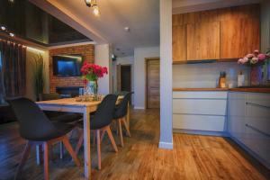 a kitchen and dining room with a table and chairs at Na Skraju Raju in Zator