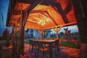 an outdoor dining area with a table and chairs at Na Skraju Raju in Zator