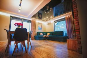 a living room with a table and a blue couch at Na Skraju Raju in Zator