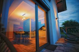a view of a dining room and kitchen through a window at Na Skraju Raju in Zator