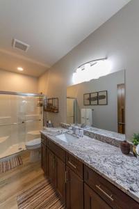 a bathroom with a sink and a shower and a toilet at Wonderful Triplex Unit With Spectacular Lake View! in Valley
