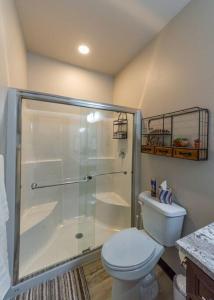 a bathroom with a toilet and a glass shower at Wonderful Triplex Unit With Spectacular Lake View! in Valley