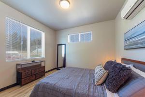 a bedroom with a bed and a dresser and a window at Gorgeous Triplex Unit With Spectacular Lake Views! in Valley