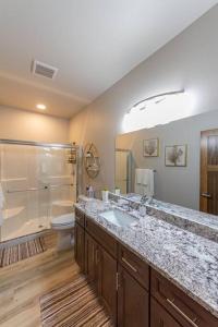 a bathroom with a sink and a shower and a toilet at Gorgeous Triplex Unit With Spectacular Lake Views! in Valley