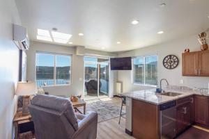 a kitchen and living room with a couch and a chair at Gorgeous Triplex Unit With Spectacular Lake Views! in Valley