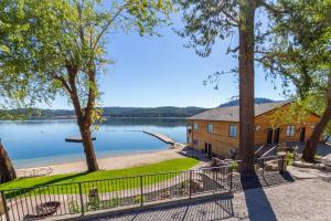 a house on the shore of a lake at Gorgeous Triplex Unit With Spectacular Lake Views! in Valley