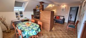 a dining room with a table and chairs in a room at Apartment Kranj - huge terrace, free P, WI - FI, AC in Kranj