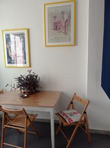 a table and two chairs and a picture on a wall at CasaRA in Bari