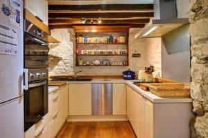 cocina con armarios blancos y encimera en Finest Retreats - Hope House - Ty Gobaith, en Dolgellau