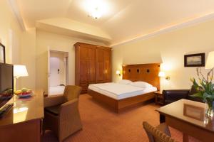 a hotel room with a bed and a living room at Vju Hotel Rügen in Göhren