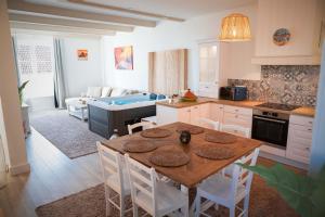 a kitchen with a table and chairs and a kitchen with a couch at Slocations in Vandoeuvre-lès-Nancy