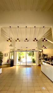 a large room with a kitchen and a hallway with lights at Hotel Les Pavillons Du Golfe in Favone