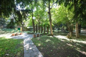 un camino en un parque con árboles y bancos en Easylife - Moderno bilocale in zona Porta Romana, en Milán