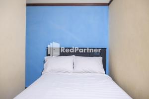 Postel nebo postele na pokoji v ubytování Athaya Hotel Syariah near UGM Yogyakarta Mitra RedDoorz