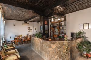 un restaurant avec un bar doté de chaises et de tables dans l'établissement Family Hotel Bile, à Beli Osam