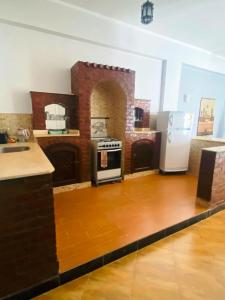 a kitchen with a stove and a refrigerator at Temple House Luxor in Luxor