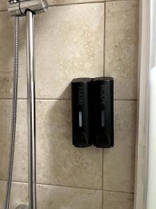 a couple of black batteries on the floor of a shower at Top Floor in Lincoln