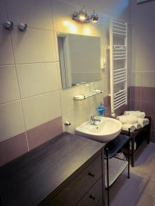 a bathroom with a sink and a mirror at Garda Hotel in Szombathely