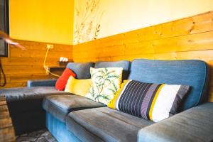 a couch with colorful pillows on it in a room at Wild East Country House in Manzhou