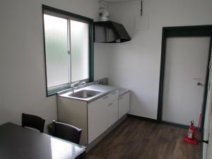 a kitchen with a sink and a window and a table at Fukuoka - House / Vacation STAY 4617 in Fukuoka
