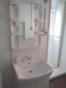 a white bathroom with a sink and a mirror at Fukuoka - House / Vacation STAY 4617 in Fukuoka