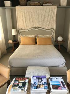 Un dormitorio con una cama y una mesa con revistas. en Bed&Breakfast La Madonnina, en Marlia