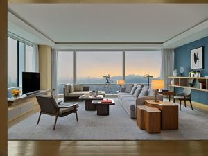 a living room with a couch and a tv at Mandarin Oriental, Shenzhen in Shenzhen