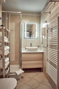 a bathroom with a sink and a mirror at Vila Piranesi Apartments - Parking included in Piran