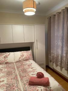 a bedroom with a bed with a red towel on it at Canal View in Belmullet