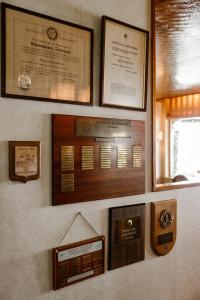 a wall with a bunch of certificates and pictures on it at Hotel Restaurant Belv&eacute;d&egrave;re in Schoonhoven