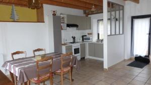 a kitchen and dining room with a table and chairs at La ferme de la Cavalerie in Saint-Gonnery