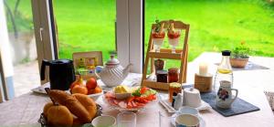 a table with a breakfast of bread and fruit at Landhaus Gerstgraser in Rauris +24 photos