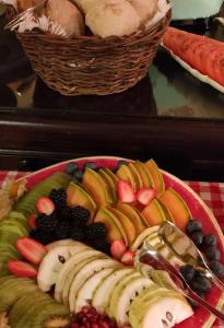 a plate of fruit and vegetables on a table at Charming Antas House in Porto