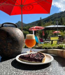a piece of cake and a glass of beer on a table at Gîte les 3 cols in Réallon