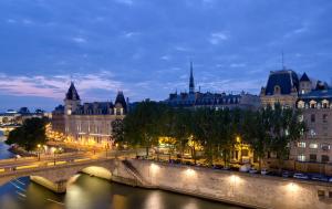 un ponte su un fiume in una città di notte di Les Rives de Notre-Dame a Parigi