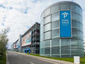 a building with a sign on the side of a road at Baltischer Sternenblick in Rostock