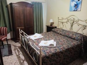 a hotel room with a bed with two towels on it at Albergo Diffuso Borgo Santa Caterina "Quartire Hebraic" in Castiglione di Sicilia
