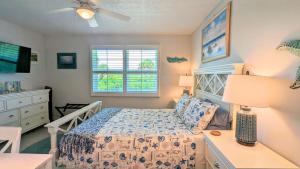 a bedroom with a bed and a dresser and a window at Beach Escape by Casago in Saint Augustine Beach