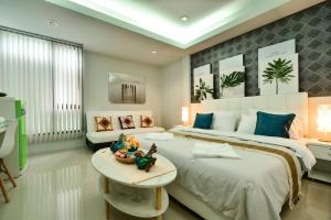 a bedroom with a large bed and a table at Sphat เอสพลัส Boutique Hotel chiang mai in Chiang Mai