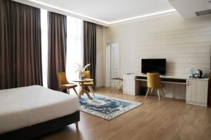 TV a/nebo společenská místnost v ubytování Hotel Colombo