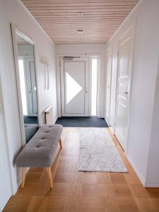 a living room with a bench and a door at Marna Guesthouse doubleroom nr.2 in Tórshavn