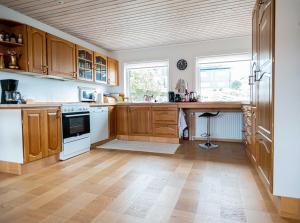 a kitchen with wooden cabinets and a wooden floor at Marna Guesthouse doubleroom nr.2 in Tórshavn