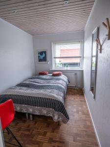 a small bedroom with a bed and a window at Marna Guesthouse doubleroom nr.2 in Tórshavn