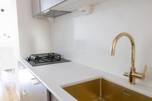 cocina con fregadero y fogones en 2ndhomes Luxury 3 BR Brand New 106 m2 Apartment with Spa in Helsinki Center, en Helsinki