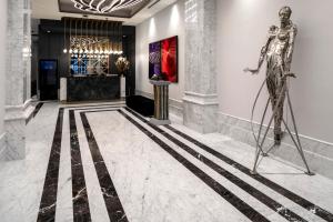 a rendering of a lobby with a statue in the foreground at Wish More Hotel Şişli in Istanbul