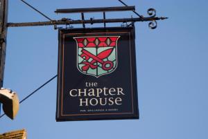 a sign for the chapter house hanging from a building at Chapter House in Salisbury