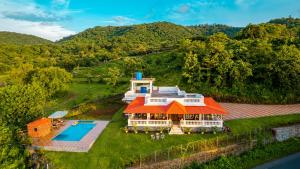 an aerial view of a house with a swimming pool at Spicy Mango Ocean Paradise - Luxurious Sea View Villa In Alibaug in Christpāda