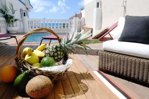 a basket of fruit sitting on a table on a patio at Villa Beauregard in Sainte-Luce