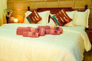 two beds with pink towels on top of them at Spicy Mango Ocean Paradise - Luxurious Sea View Villa In Alibaug in Christpāda