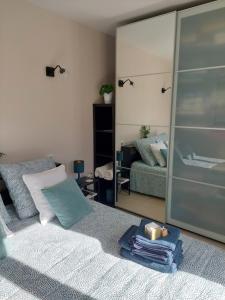 uma sala de estar com um sofá e um espelho em Magnifique suite familiale em Nans-les-Pins